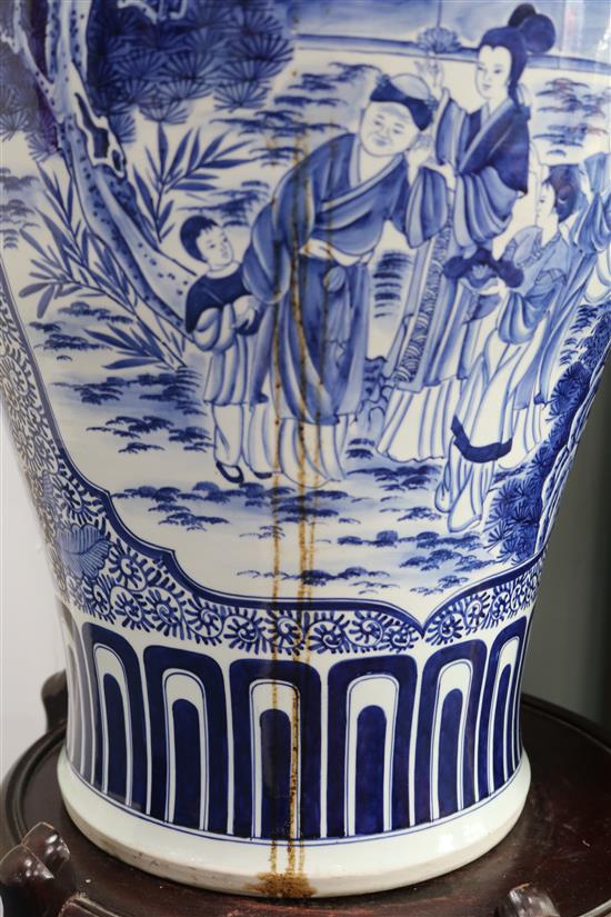 A massive Chinese blue and white vase and wood stand